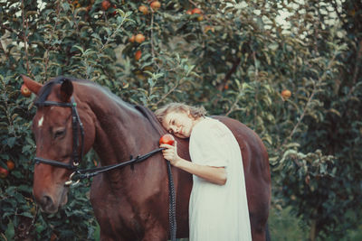 Woman standing by plants on land