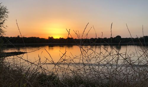 Scenic view of lake against sky during sunset