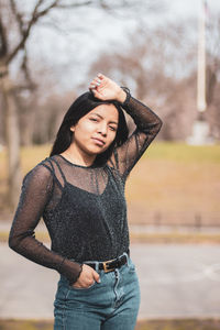 Portrait of smiling young woman standing outdoors