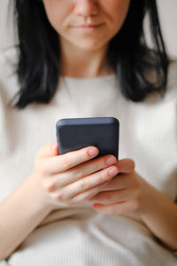 Girl holds a smartphone in her hands. touch screen smartphone, in hand. businesswoman 