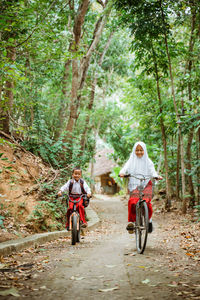 Rear view of man riding bicycle