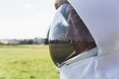 Female astronaut in space helmet looking away