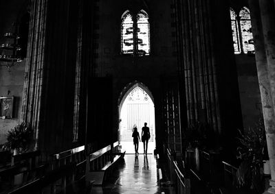 Silhouette people entering in the church