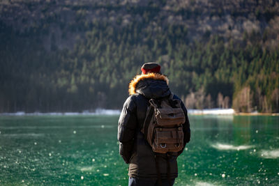 Rear view of man standing in water