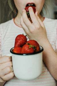 Midsection of woman holding fruits