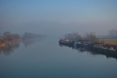 Rusty ships on foggy river