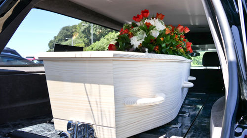 Closeup shot of a funeral casket in a hearse or chapel or burial at cemetery