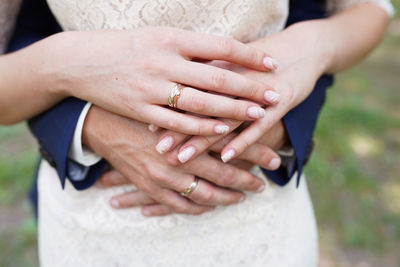 Midsection of couple holding hands