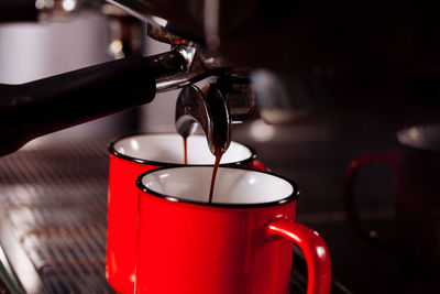 Close-up of coffee pouring in cup