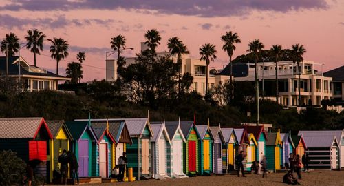 Multi colored umbrellas against sky at sunset