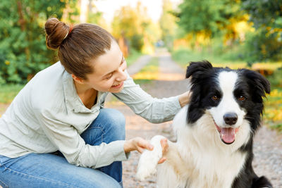 Rear view of senior woman with dog