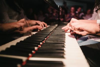 Midsection of man playing piano