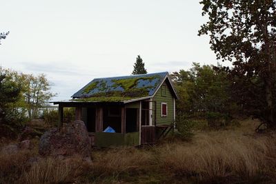 Abandoned house on field against clear sky