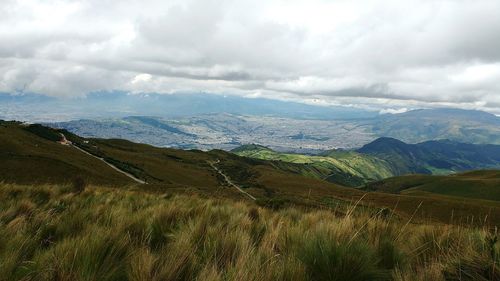 Scenic view of mountains against cloudy sky