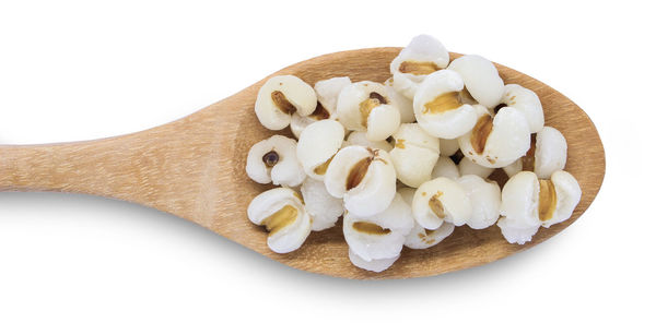 Close-up of cake on cutting board against white background