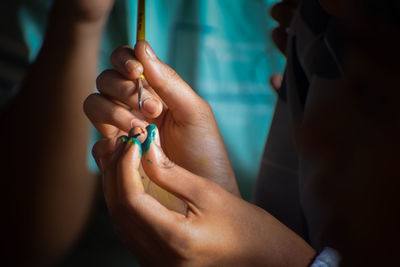 Cropped hand of doctor holding cigarette