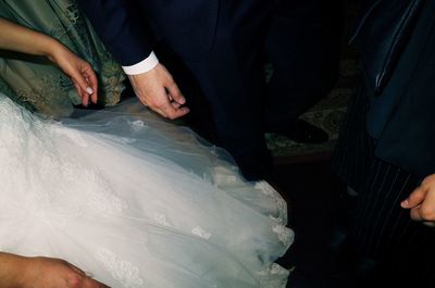 Midsection of man holding hands