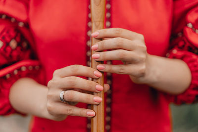 Midsection of woman playing guitar