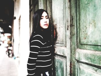 Close-up portrait of young woman standing outdoors