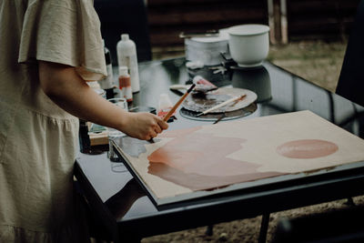 Midsection of man working on table