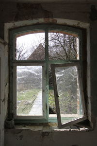 Abandoned building seen through window