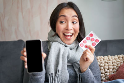 Portrait of young woman using mobile phone