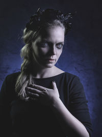 Spooky woman standing against black background