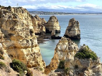 Panoramic view of rocks on sea against sky