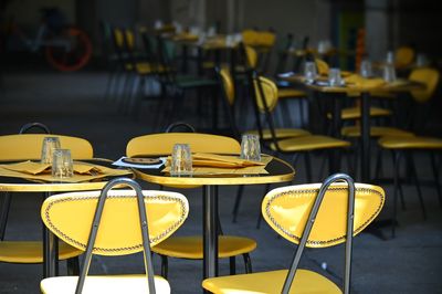 Empty chairs and tables in restaurant terrace