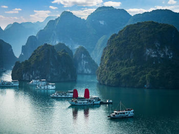 Scenic view of river and mountains against sky