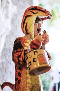 Boy dressed in dragon costume for halloween party