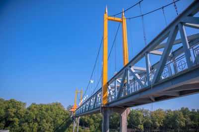 Low angle view of bridge against clear blue sky