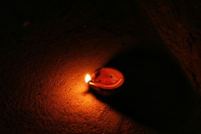 High angle view of illuminated candle