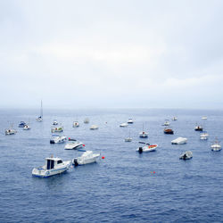 Boats on sea against sky