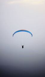 Man paragliding against clear sky