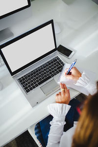 High angle view of using laptop on table
