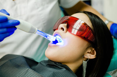 Close-up of woman holding dentures