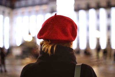Rear view of woman in red hat