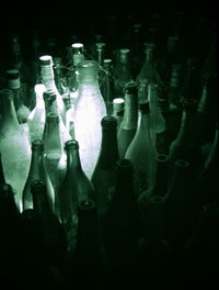 Close-up of wine bottles against black background