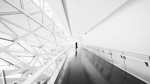 Rear view of man walking in corridor