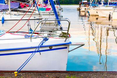 View of fishing boats moored at harbor