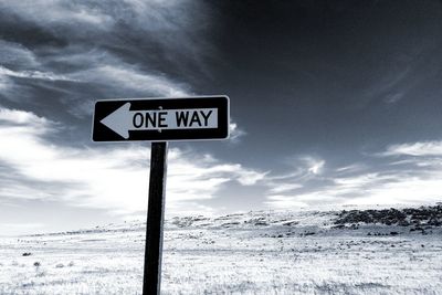 Low angle view of road sign against sky