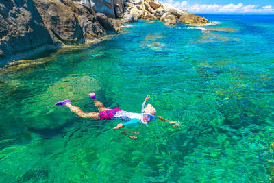 High angle view of woman swimming in sea