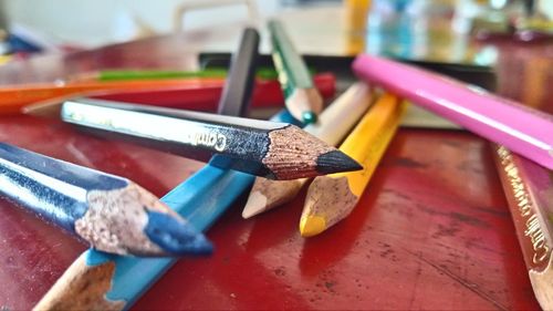 Close-up of multi colored pencils on table