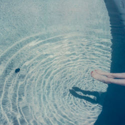 Man holding umbrella in sea