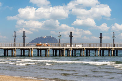 Bridge over sea against sky