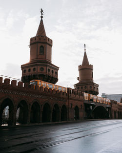 View of historic building and train against sky