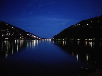 Scenic view of lake against sky at night