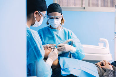 Dentists examining patient in clinic