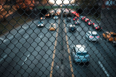 Close-up of chainlink fence against road